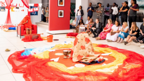 image from the artist live performance called "ENKUNDLENI/Poured Healing" which features her on the ground